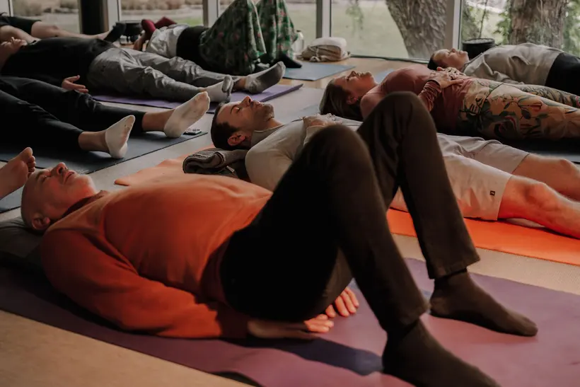 Founders lying on mats during a guided breathwork session