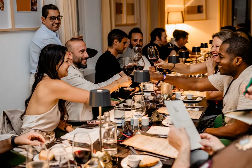 Founders sharing a long-table network dinner